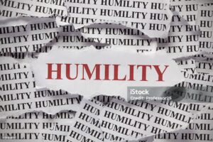 Torn pieces of paper with words "Humility"